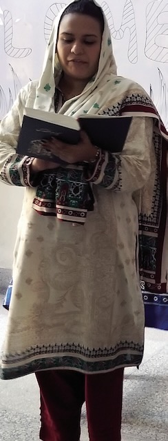 A Pakistani sister of Loretto is shown reading a bible passage wearing an intricately patterned outfit.