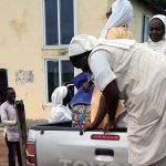 Ghanian religious sisters are shown packing up a silver Toyota truck bed with supplies in order to serve the rural poor in the area.