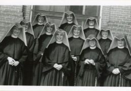 Archival photo of the 1949 Loretto Heights College reception class - eleven women in habits posing for a photo with joyous expressions on their faces.