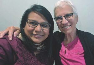 Two Catholic sisters take a selfie together, on the left is a novice from Pakistan and on the right is a sister with at many years of service.